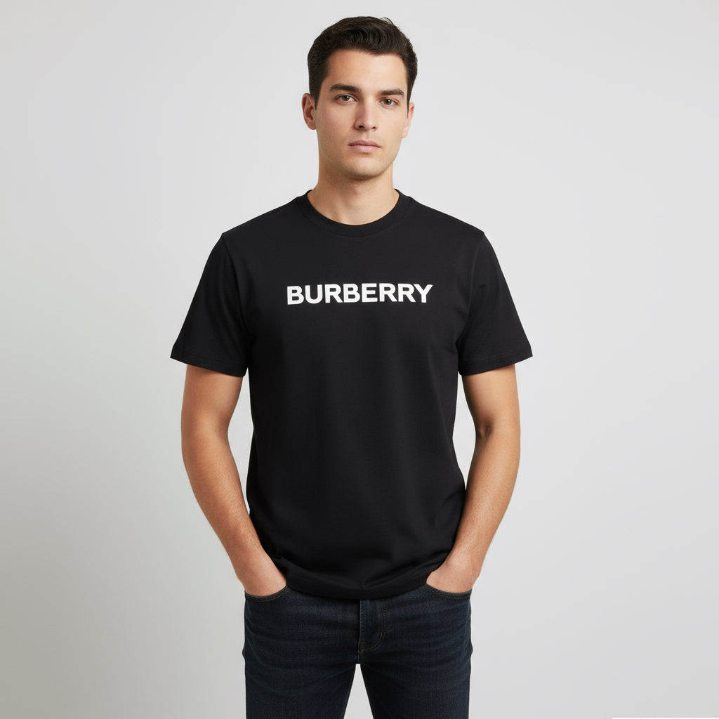 Person wearing a black Burberry t-shirt on a gray background
